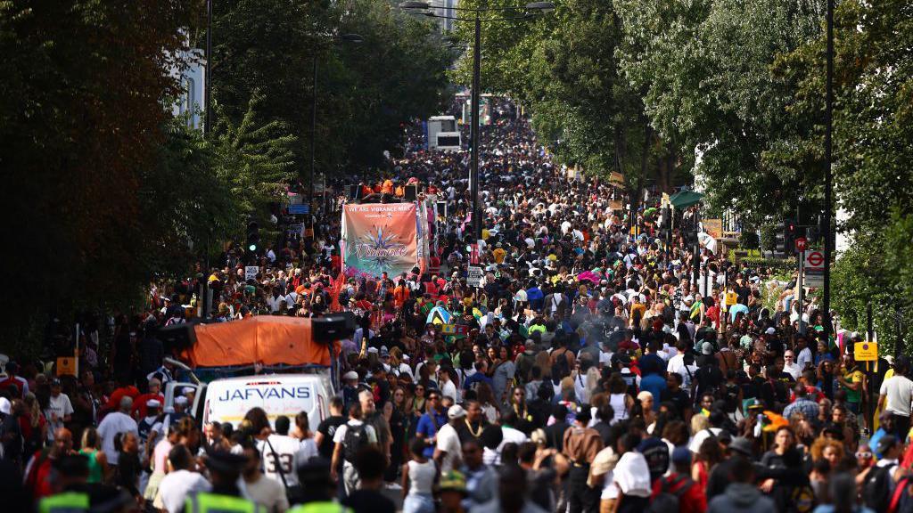 Long shot of thousands of people along the parade route in Notting Hill