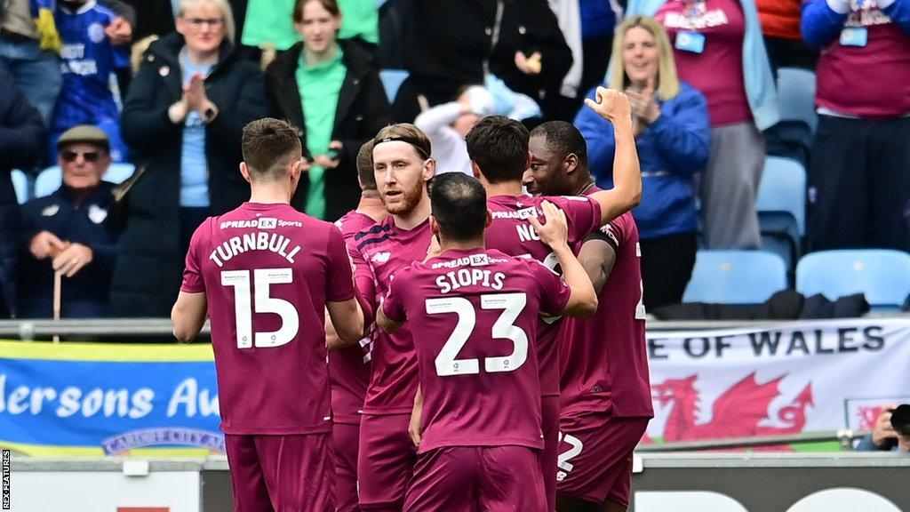 Cardiff players celebrate their second goal at Coventry