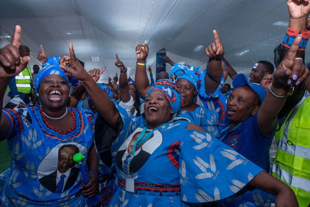 Party supporters and delegates dance at the opening day of the Democratic Progressive Party's elective convention in Blantyre. They are wearing matching blue clothing.