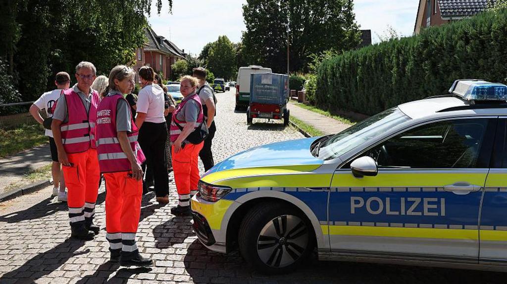 Emergency response scene outside the welfare center in Stade, Germany following the shooting