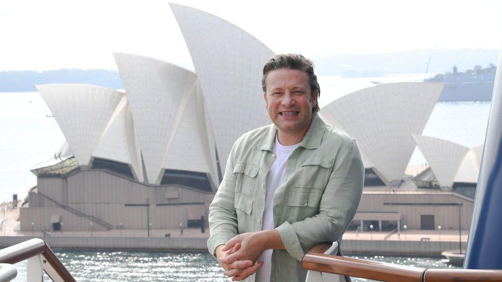 Jamie Oliver stands in front of the Sydney Opera House