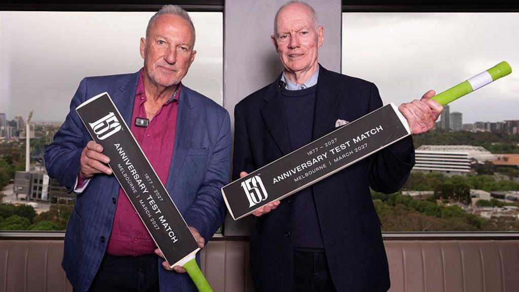 Former England captain Ian Botham and ex-Australia skipper Greg Chappell holding bats to promote the 150th anniversary Test