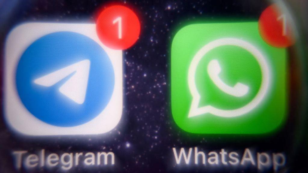 Photograph showing the mobile messaging and call service Telegram logo and US instant messaging software WhatsApp logo on a smartphone screen.