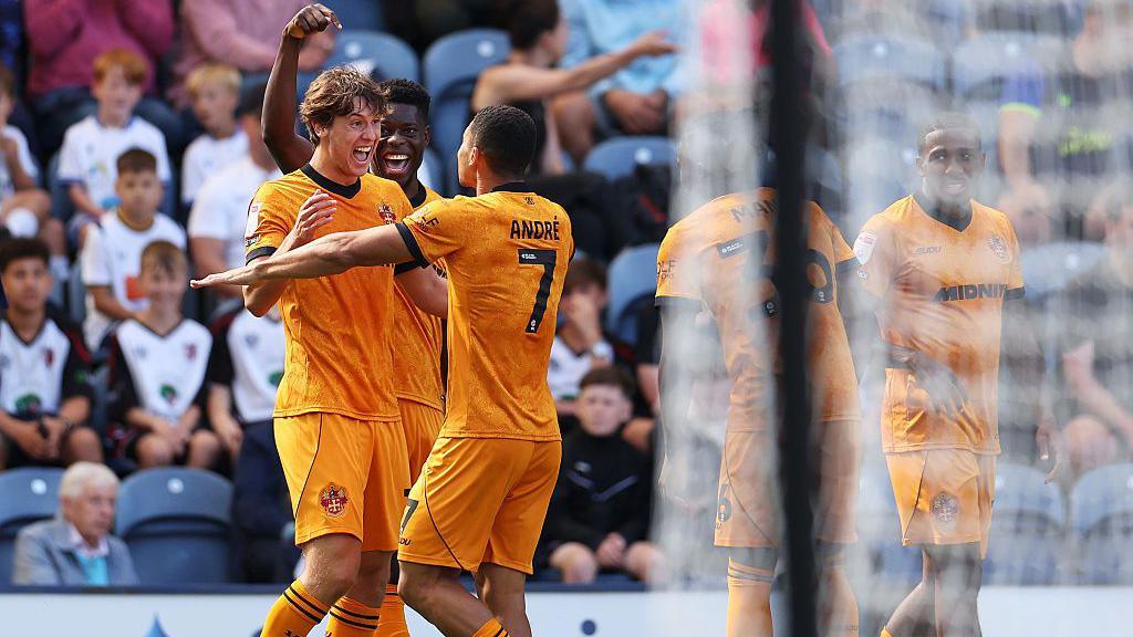 Fer Lopez of Wolves celebrates a goal with his team-mates wearing gold kits