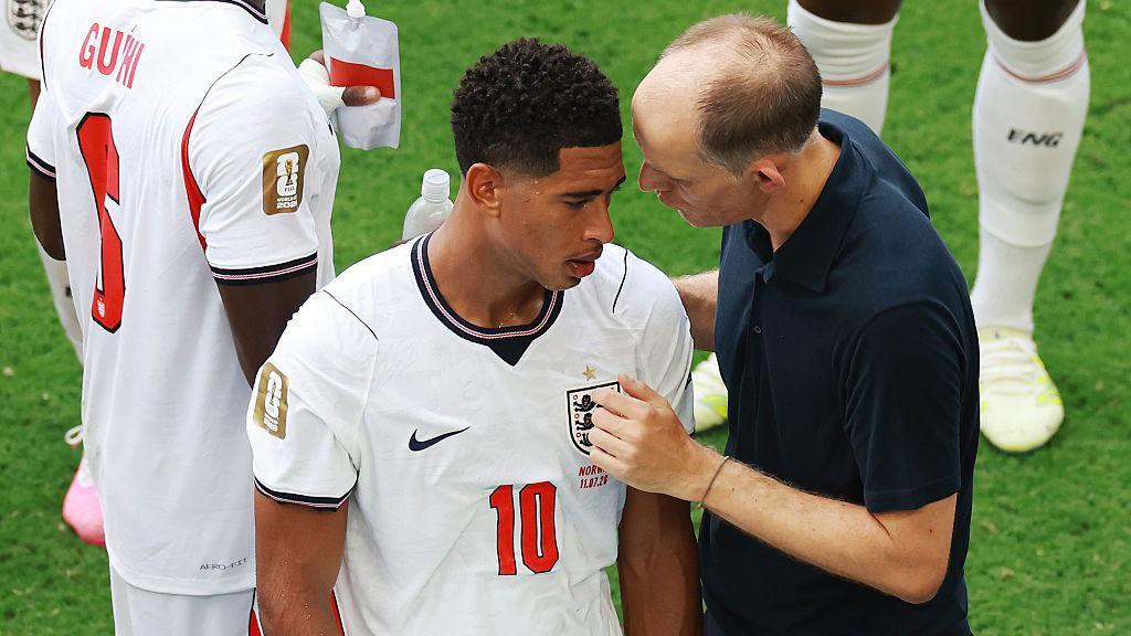 Thomas Tuchel, Manager of England, speaks with Jude Bellingham #10 during a hydration break in the FIFA World Cup 2026 Quarter Final match between Norway and England at Miami Stadium on July 11, 2026 in Miami Gardens, Florida