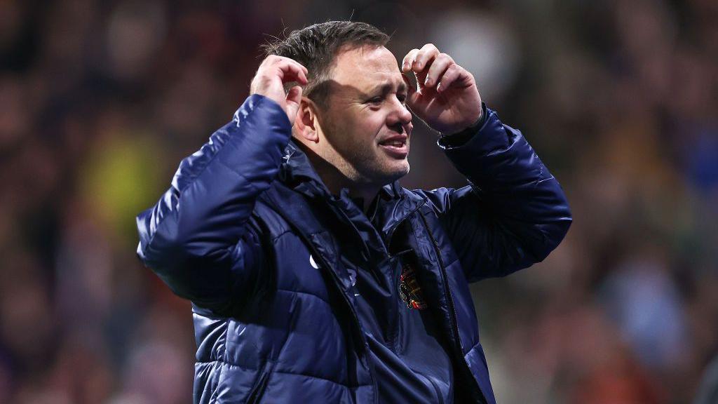 Michael Beale holds his head in his hands after defeat at Birmingham City