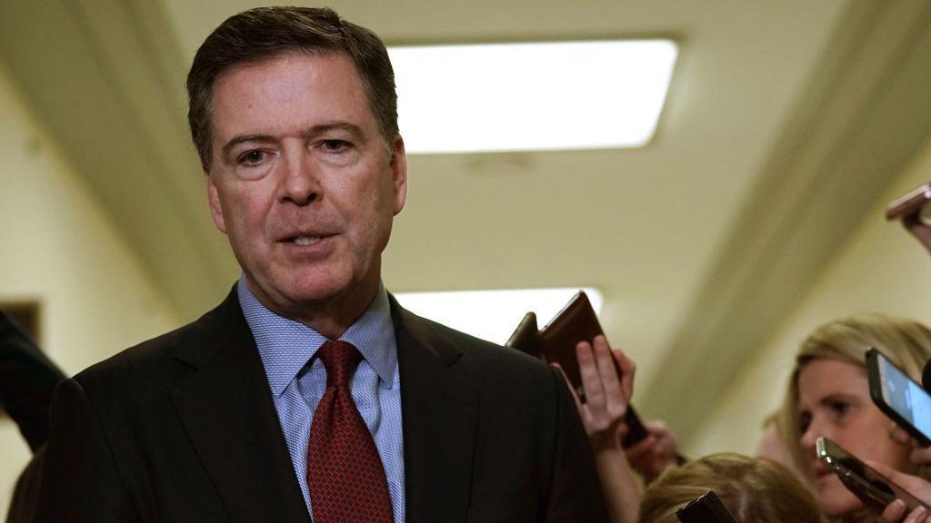 Former Federal Bureau of Investigation Director James Comey speaks to members of the media at the Rayburn House Office Building. 