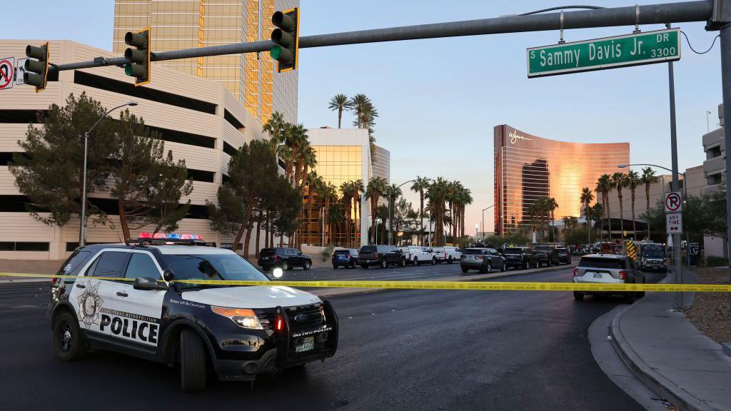 A police care blocks the road near the Trump International Hotel in Las Vegas