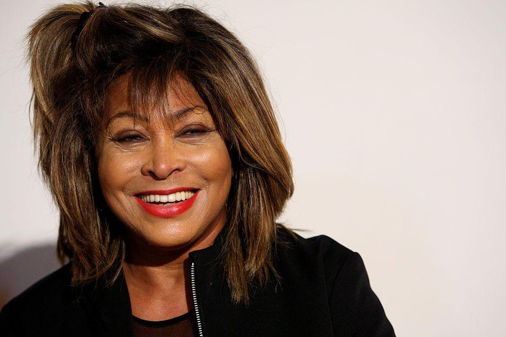 A portrait of Tina Turner, smiling at the camera