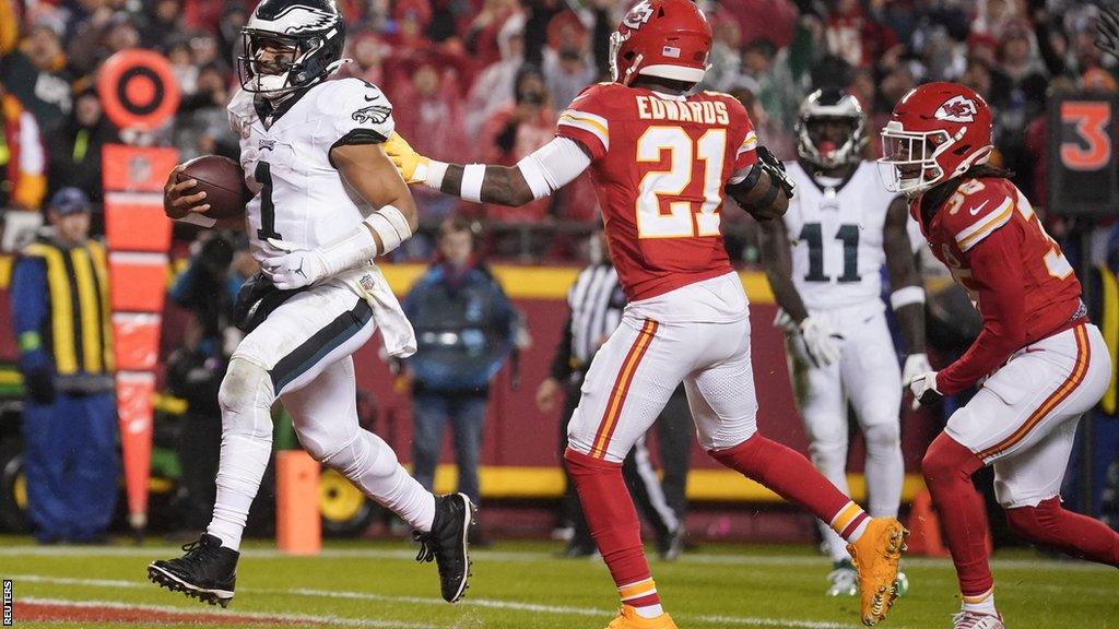 Jalen Hurts scores a touchdown as Kansas City Chiefs cornerback L'Jarius Sneed attempts a tackle during the Philadelphia Eagles' victory at Arrowhead Stadium