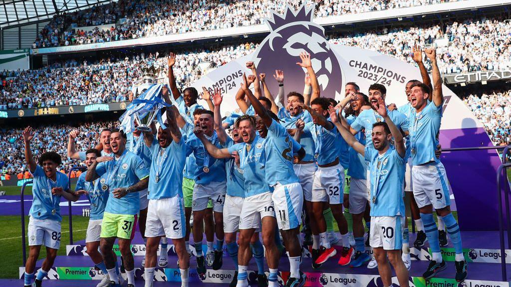 Kyle Walker of Manchester City lifts the Premier League trophy with team mates for a record fourth consecutive time during the Premier League match between Manchester City and West Ham United at Etihad Stadium