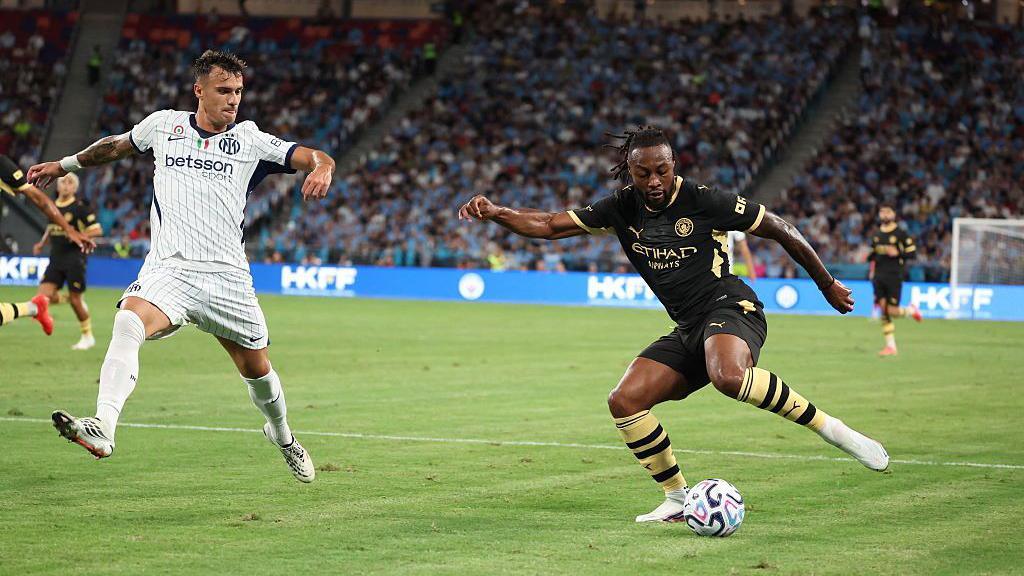 El centrocampista del Inter de Milán, Aleksandar Stankovic, y el centrocampista del Manchester City, Antoine Semenyo, luchan por el balón.