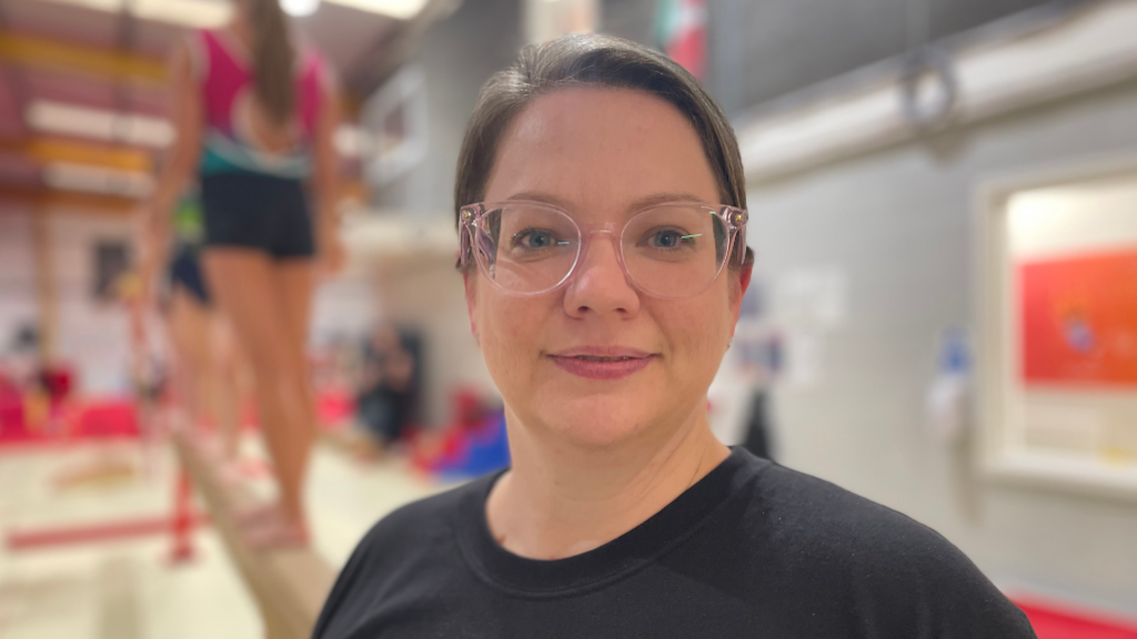 Melissa poses for a photograph in her gymnastics academy