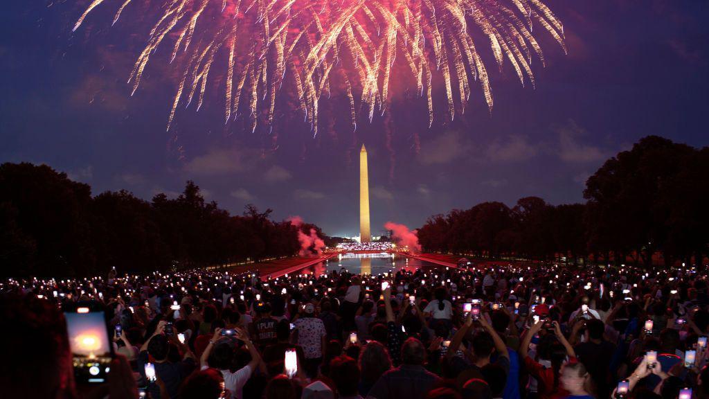 Attendees watch the Independence Day fireworks display along the National Mall in Washington, DC.