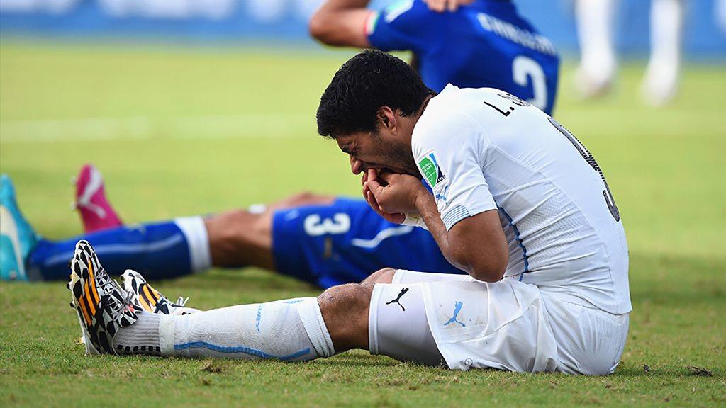 Luis Suarez on the ground just after biting Giorgio Chiellini