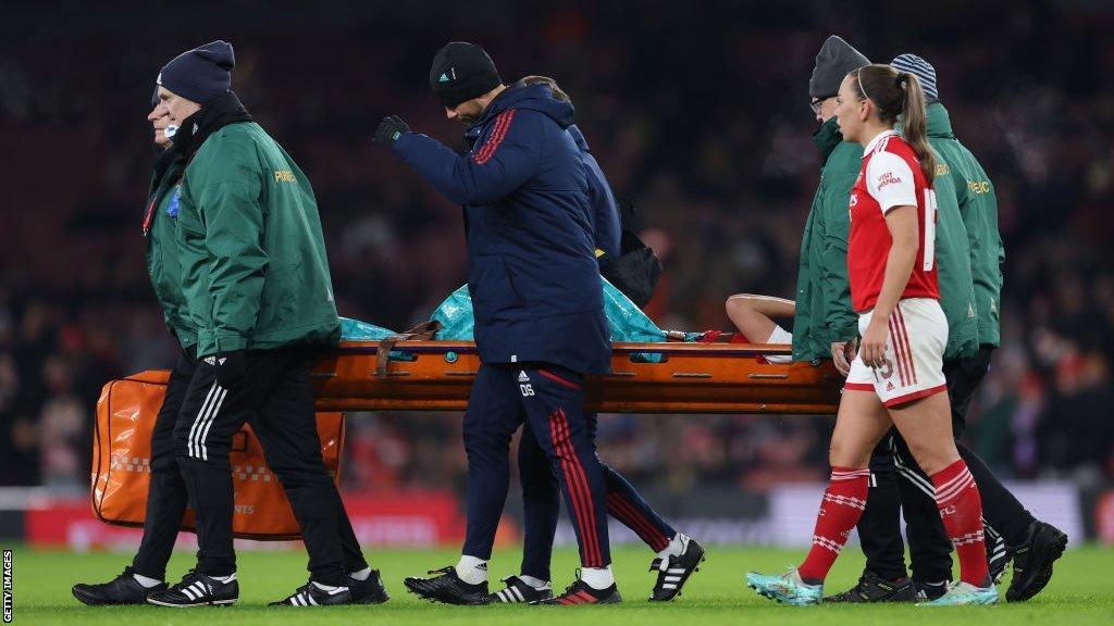 Vivianne Miedema of Arsenal lies on the ground after picking up a serious leg injur