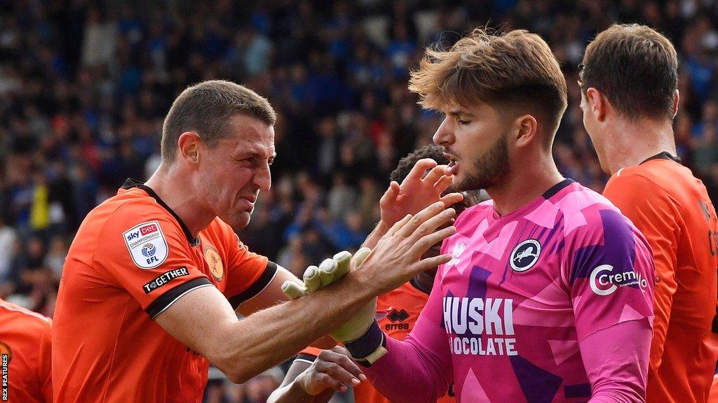 Millwall players congratulate goalkeeper Matija Sarkic after saving a penalty