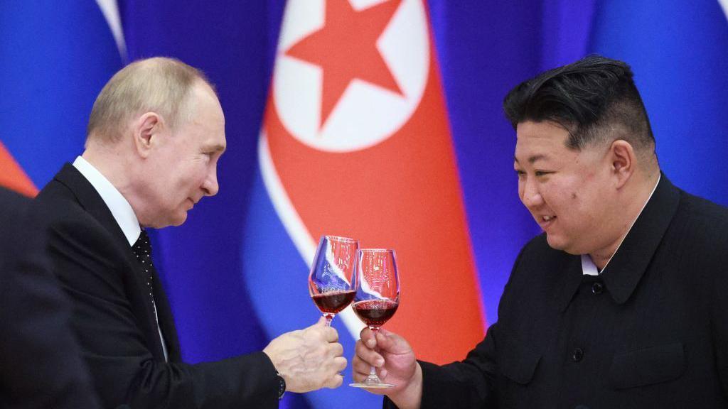 Russian President Vladimir Putin and North Korean leader Kim Jong Un toast during a reception at the Mongnangwan Reception House in Pyongyang on June 19, 2024