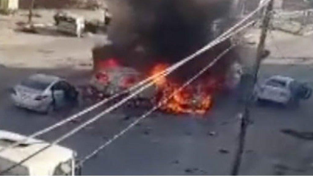 Cars on fire after a missile strike on convoy of civilians