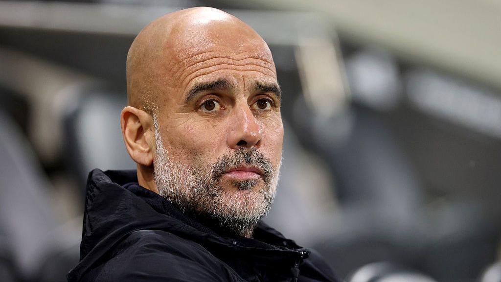 Manchester City manager Pep Guardiola looks into the distance against Fulham this season