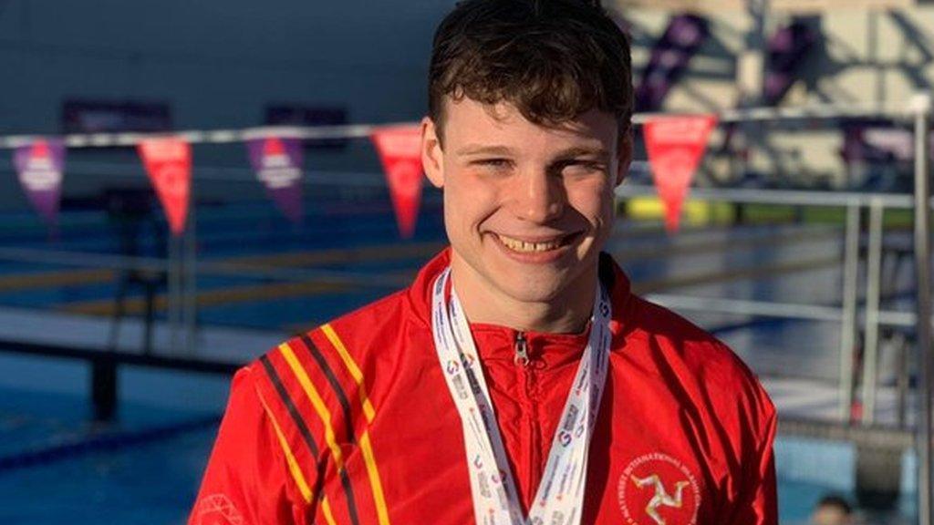 Alex Bregazzi wears some of the medals that he has won at the Island Games