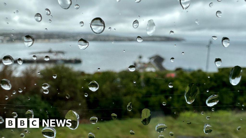 Rain on a window overlooking the sea