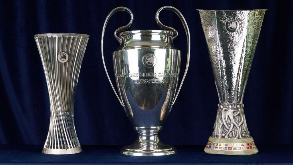 Picture of the Champions League, Europa League and Conference League trophies