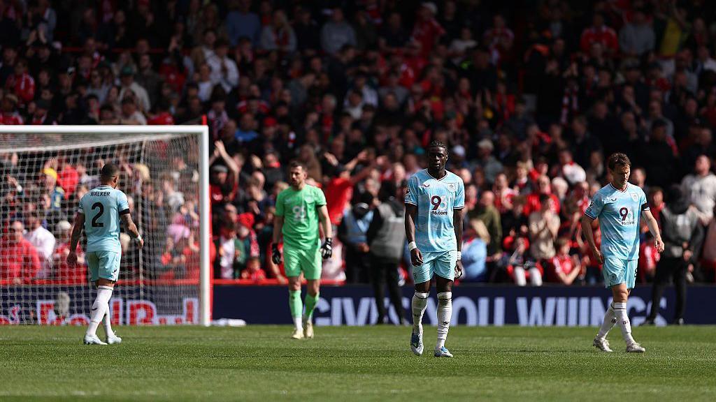 Burnley players look dejected after conceding a third goal