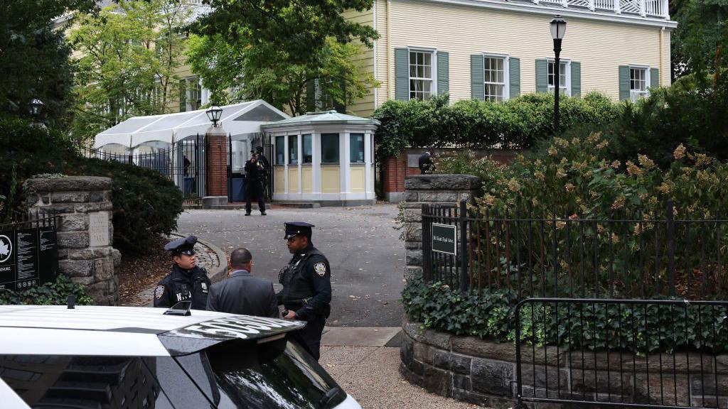 NYPD officers patrol Gracie Mansion, the Mayor's residence, on 26 September in New York City