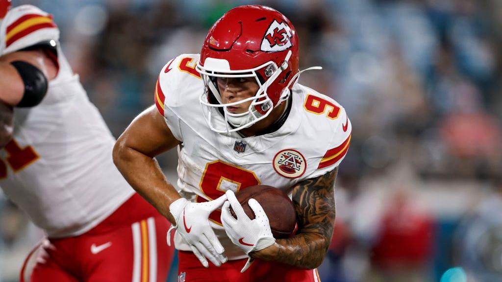 Louis Rees-Zammit carries the football against the Jacksonville Jaguars