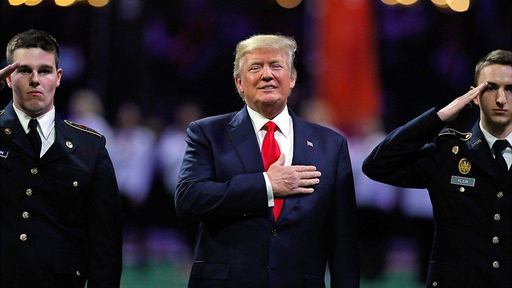 President Donald Trump on field during the national anthem prior to the CFP National Championship between the Georgia Bulldogs and the Alabama Crimson Tide at Mercedes-Benz Stadium on January 8, 2018.