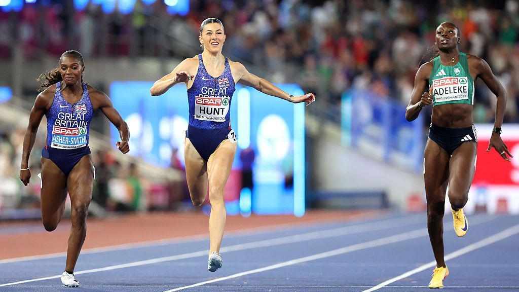Amy Hunt (in the centre) crosses the finish line to win the gold medal ahead of Ireland's Rhasidat Adeleke (on the right) and team-mate Dina Asher-Smith (on the left)