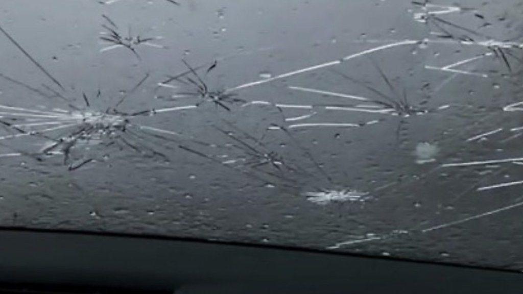 Hailstones smashed car windows.