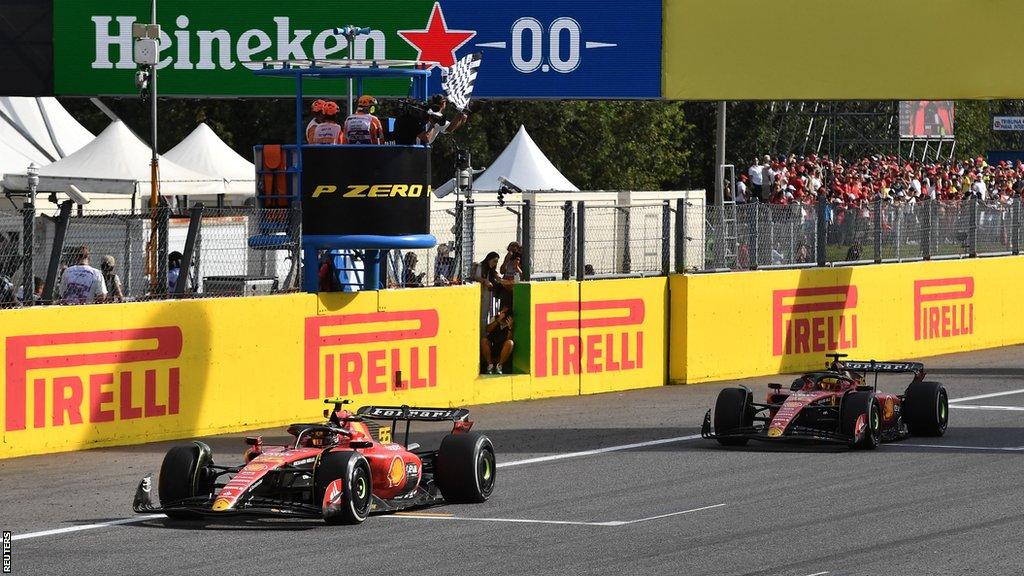 Carlos Sainz crosses the finish line just ahead of Ferrari team-mate Charles Leclerc