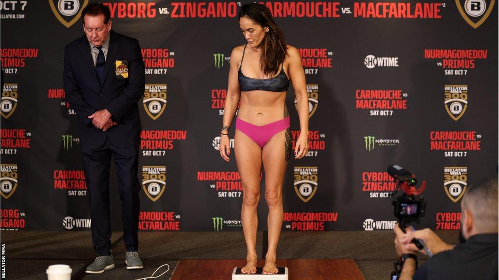 Ilima-Lei Macfarlane looks down at the scales as she weighs in