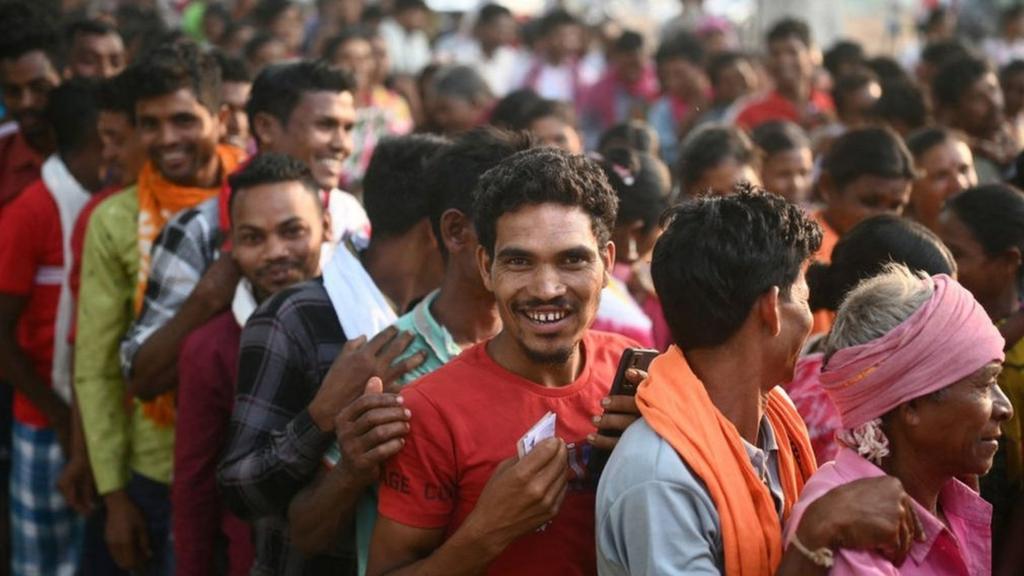 Voters queue up to cast their ballot outside a polling station during the first phase of voting for the India's general election, in Dugeli village of Dantewada district of Chhattisgarh state on April 19, 2024.