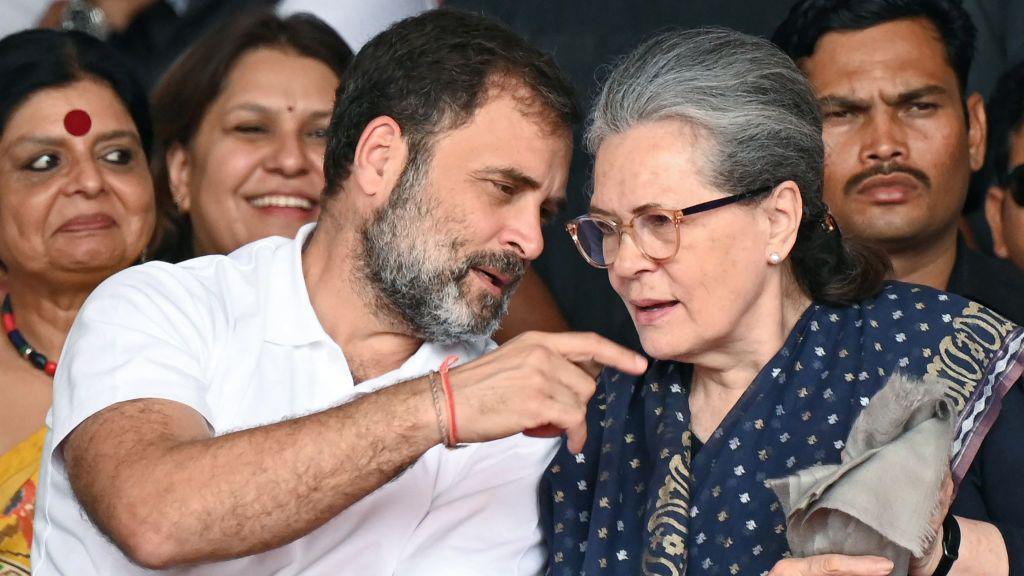 Congress party leaders Rahul Gandhi wearing a white tshirt and Sonia Gandhi (R) wearing a blue saree talk during swearing in ceremony of Chief Minister of Telangana state, in Hyderabad on December 7, 2023.