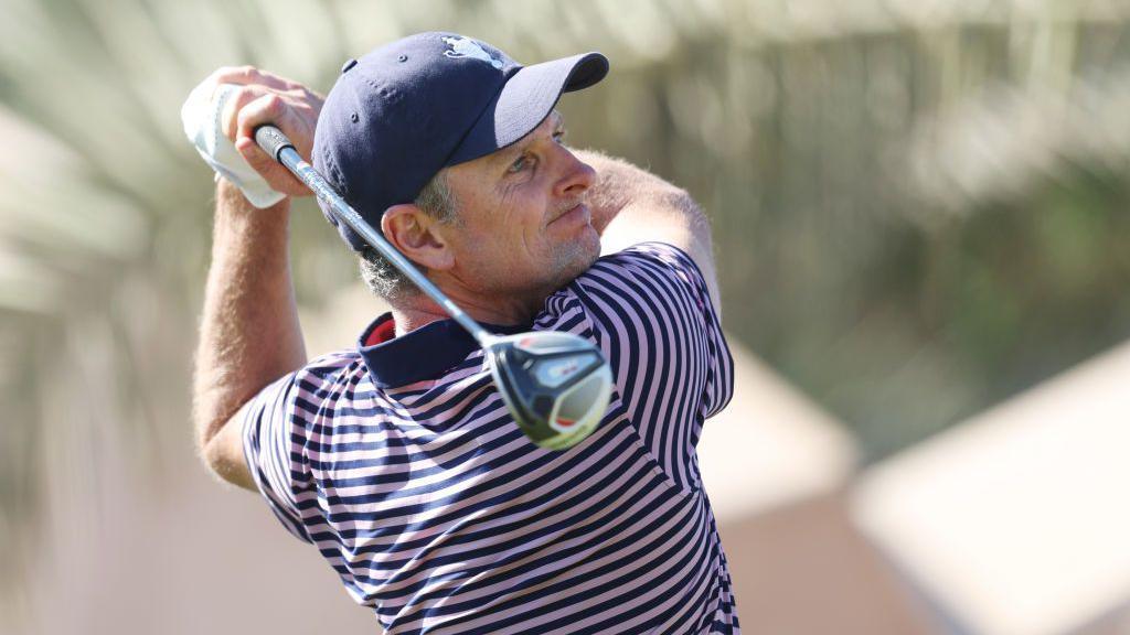 Justin Rose, captain of Team Great Britain & Ireland tees off on the 18th hole during the foursomes matches on day two of the Team Cup at Abu Dhabi Golf Resort 