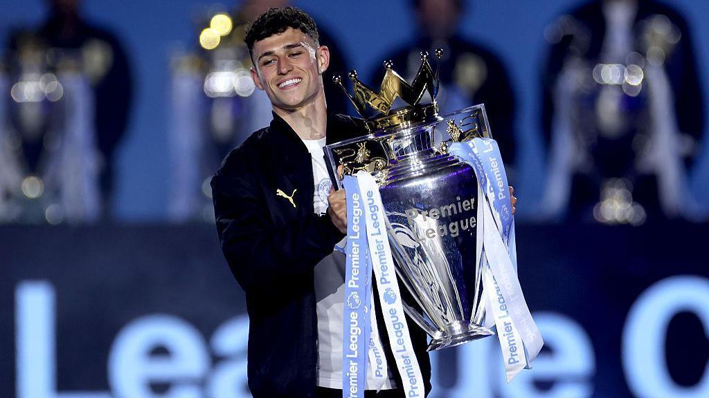 A recent picture of Phil Foden holding the Premier League trophy