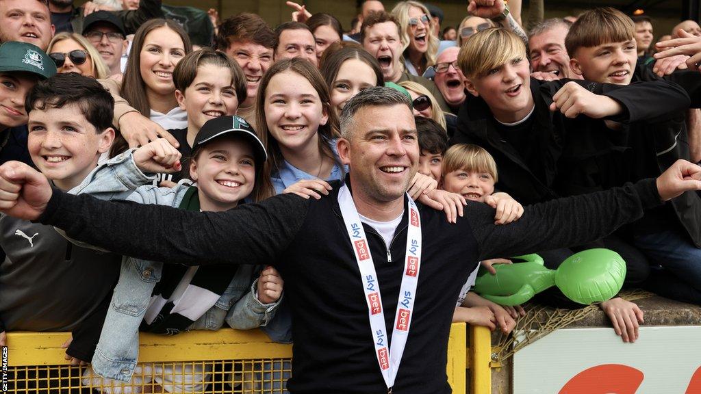 Steven Schumacher celebrates with the Argyle fans