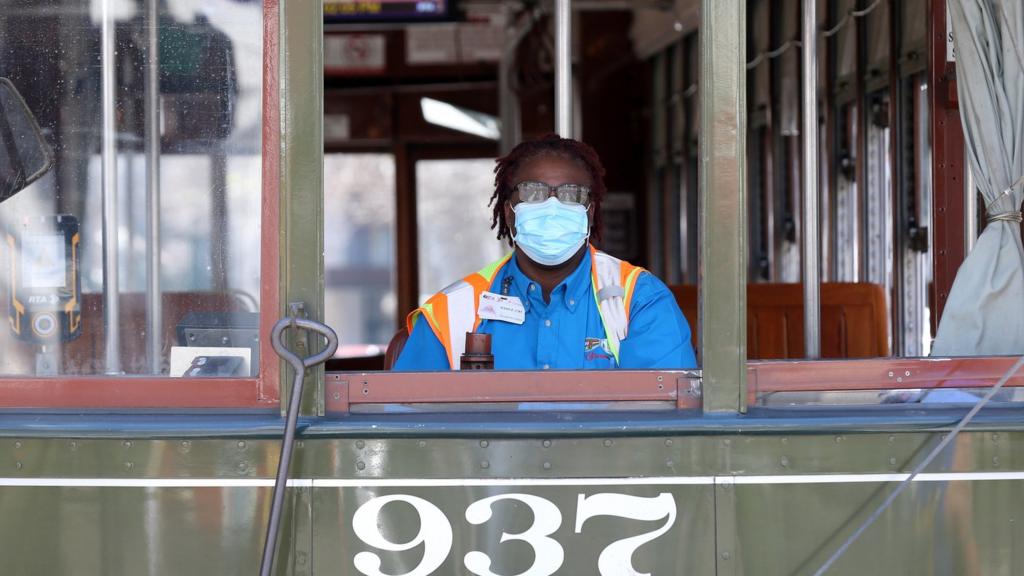 A streetcar worker in the US wears a facemask amid the coronavirus outbreak