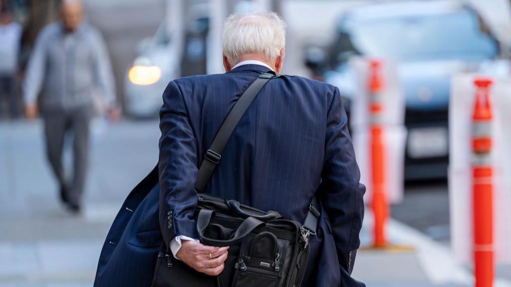 A pedestrian in San Francisco, California, US, on Tuesday, May 7, 2024. US job openings fell in March to the lowest level in three years while quits and hiring slowed, indicating more softening in the labor market. 