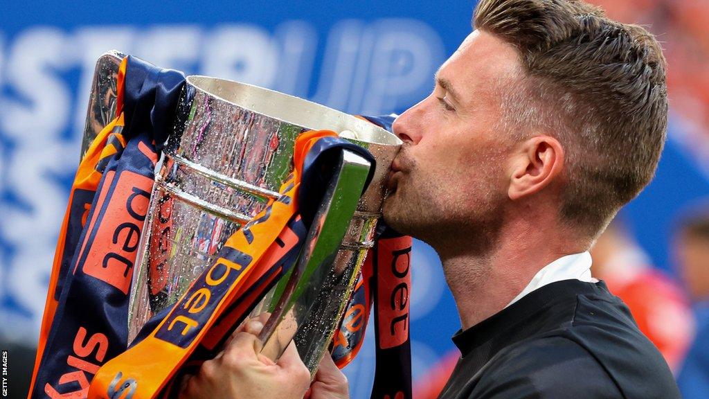 Rob Edwards kisses the Championship play-off final winners' trophy