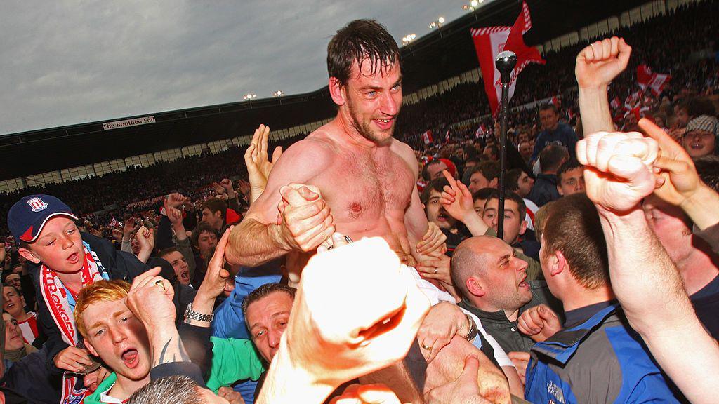 Stoke's Rory Delap celebrates with fans after winning promotion to the Premier League in 2008