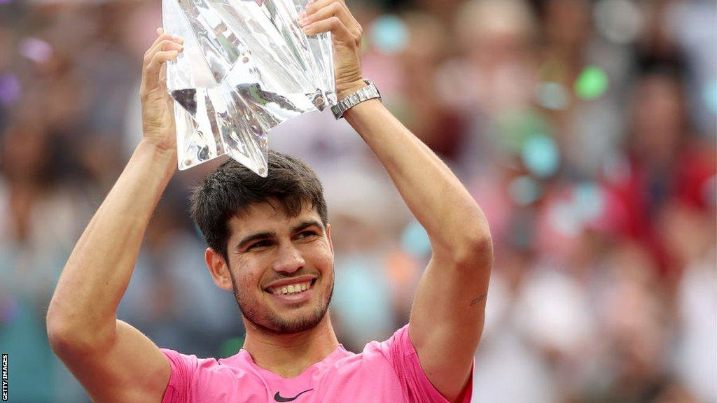 Carlos Alcaraz celebrates with the Indian Wells trophy