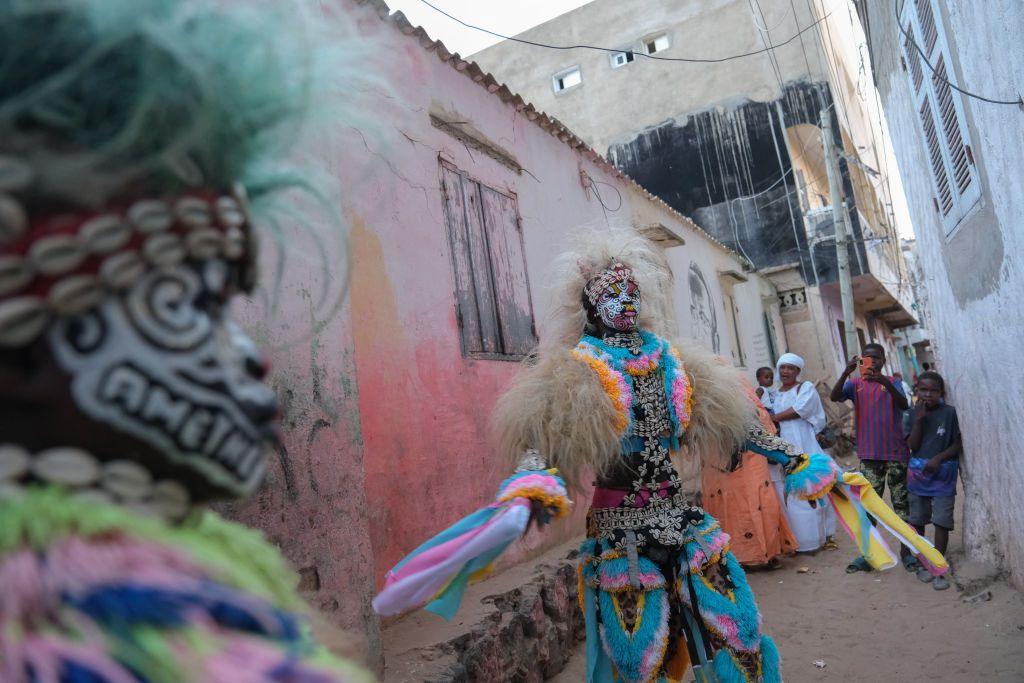 A performer dances in a traditional Simb costume during a cultural show at Ngor in Dakar, on 12 August 2024