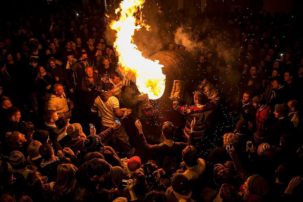  A burning barrel soaked in tar is carried through the crowds at the annual Ottery St Mary Tar Barrel festival on November 5 2013 in Ottery St Mary, Devon, England.