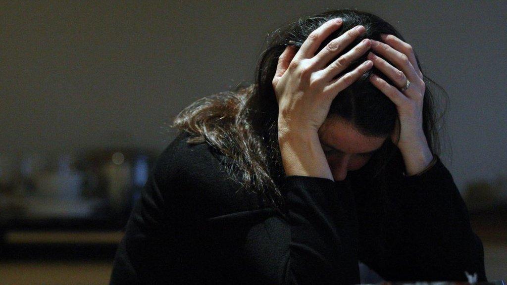 Stock picture of woman with head in hands