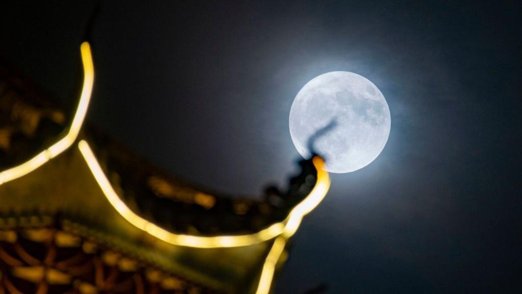 Blue supermoon above a building structure in China