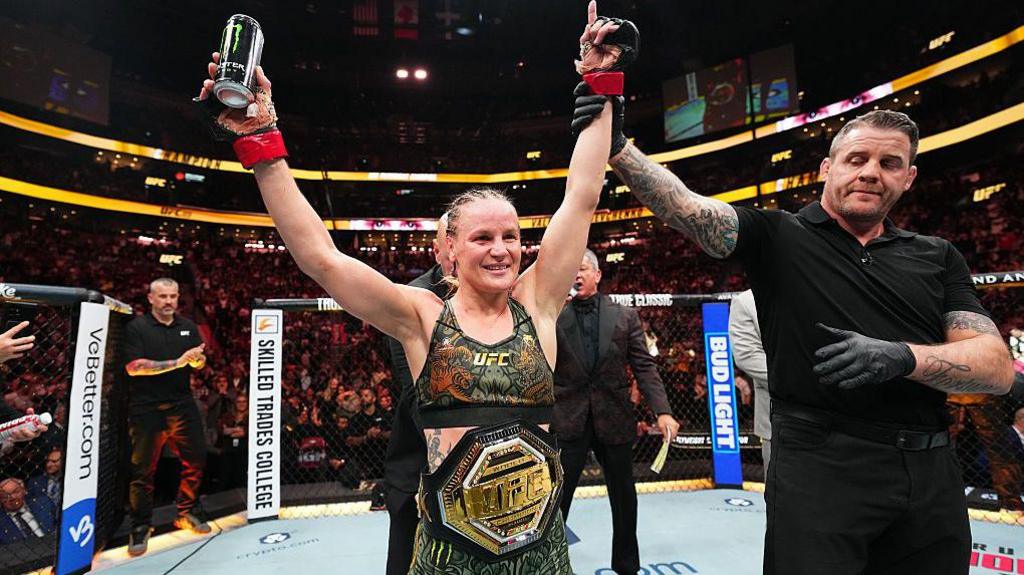 Valentina Shevchenko has her arm lifted after victory over Manon Fiorot.